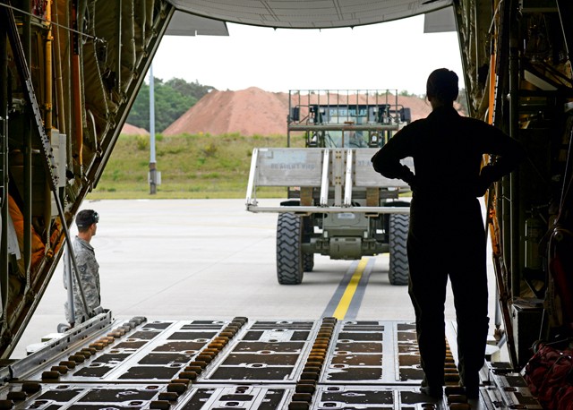 Photo by Airman 1st Class Tryphena Mayhugh Airman 1st Class Sarah Meadows, 37th Airlift Squadron loadmaster, waits for cargo to be loaded onto a C-130J Super Hercules May 27, 2015, on Ramstein. The cargo was flown to Kosovo for an airdrop training exercise.