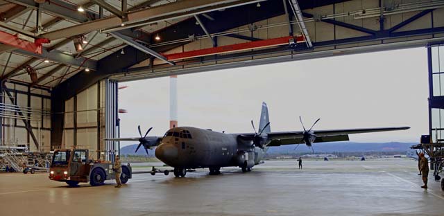 Airmen from the 86th Maintenance Squadron tow a Ramstein C-130J Super Hercules into a hangar Jan. 1 on Ramstein. The aircraft was being moved into the hangar to complete a C-2 isochronal inspection, which is a complete examination of the aircraft to perform necessary and preventative maintenance.