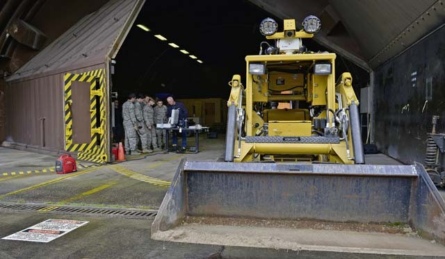 Airmen from the 786th Civil Engineer Squadron Explosive Ordnance Disposal configure their remote computer as they prepare to do maintenance on their All-Purpose Remote Transport System Jan. 28 on Ramstein. The Airmen tested the ARTS on maneuvering through an environment and locating objects scattered around the training area.