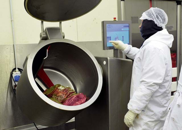 Sven Fischer, Defense Commissary Agency employee, adds spices and oil to beef before packaging at the Ramstein Central Meat Processing Plant Jan. 25 on Ramstein. The Ramstein CMPP tests different spice recipes and sells them to customers for convenience and variety.