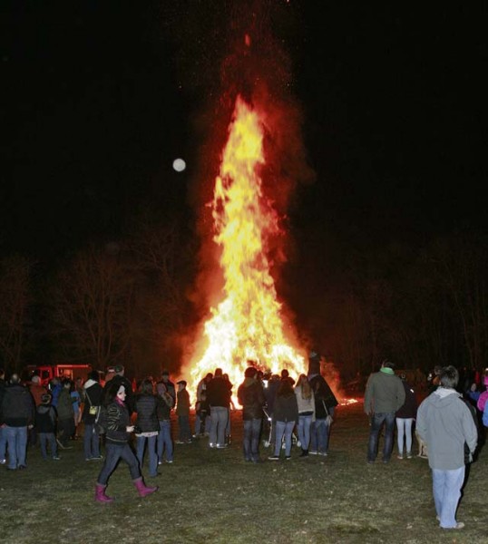 Courtesy photo People watch the pile of wood burning to say good bye to winter Saturday night in Olsbruecken.