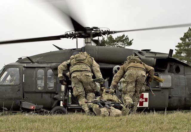 Airmen from the 2nd Air Support Operations Squadron drag a simulated casualty for medical evacuation during training Feb. 8 at U.S. Army Garrison Bavaria in Vilseck, Germany. The training consisted of calling in close air support, neutralizing opposing forces, and practicing medical evacuation by helicopter. Blank rounds and smoke grenades were used during the training to simulate the potential chaos an ASOS Airman may experience during a real-world mission.