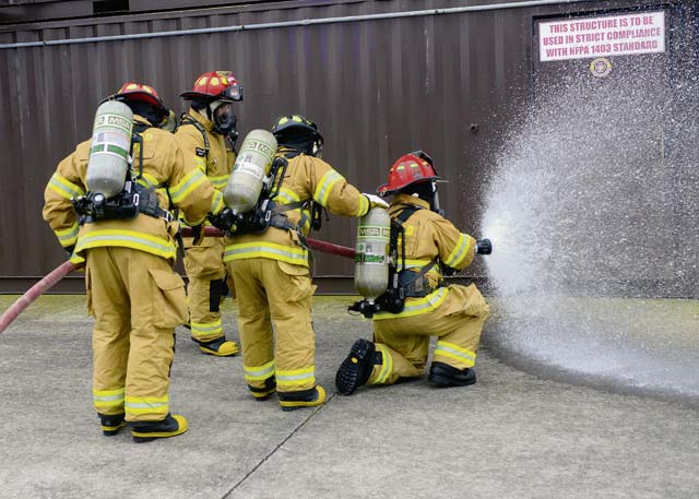 Firefighters from the 65th Civil Engineer Squadron test a fire hose before combatting a structural fire at their training facility Feb. 6 on Lajes Field, Azores, Portugal. Lajes Field, operated by the 65th Air Base Group, became a geographically separated unit of the 86th Airlift Wing in  August 2015.