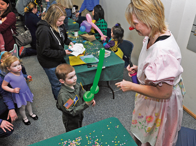 Tina Kamber, a balloon artist, makes a balloon sword for a child during a kinder Fasching celebration Jan. 25 on Ramstein. The event had games, a bounce house, a balloon artist, face painting, popcorn and dance performances.