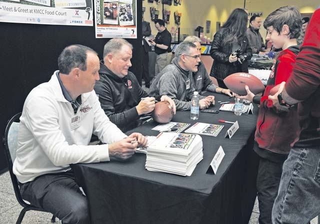 Coaches of the 2016 Coaches Tour sign autographs for a fan Feb. 14 on Ramstein. 