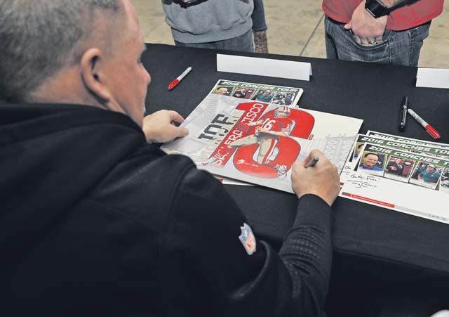Chip Kelly, San Francisco 49ers head coach, signs his autograph for a fan during the 2016 Coaches Tour Feb. 14 on Ramstein. The coaches took time to meet with fans, sign autographs and have lunch with wounded warriors. 