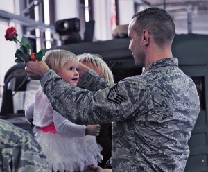 Staff Sgt. Ivor Mueller, 86th Vehicle Readiness Squadron equipment support assistant, places a medal around the neck of his daughter, Kitana, during a Homefront Heroes ceremony Feb. 19 on Ramstein. The ceremony honors children and spouses for the sacrifices they make while their family member is deployed.
