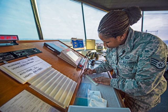 Staff Sgt. Nicole Walker, 424th Air Base Squadron air traffic controller, checks documents  Feb. 26 in the Chievres Air Base tower, Belgium. The 424th ABS operates the airfield and runways at Chievres while providing support to the Supreme Allied Commander Europe and Supreme Headquarters Allied Powers Europe, NATO transient aircraft and distinguished visitors.