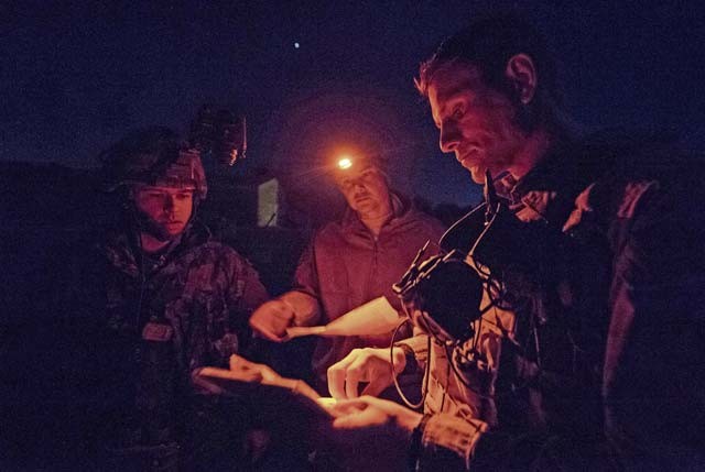Tech. Sgt. Jeremy Rarang and Senior Airman Tormod Lillekroken, 2nd Air Support Operations Squadron joint terminal attack controllers, and Master Bombardier Mathiew Marcoux-Desrochers, a joint terminal attack controller from the Yankee Battery of the 2nd Regiment, Royal Canadian Horse Artillery, discuss training objectives as part of a night training scenario during exercise Serpentex 16 March 15 in Corsica, France.