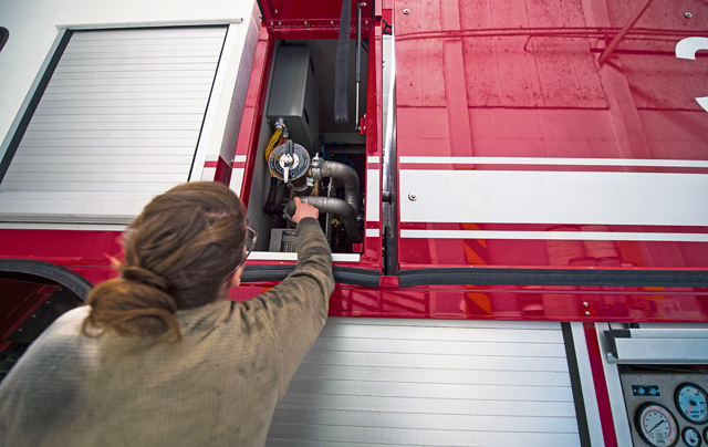 Senior Airman Nicole Franklin, 424th Air Base Squadron special vehicle mechanic, inspects the no-foam system on a Striker 1500 firetruck Feb. 26 on Chievres Air Base, Belgium.