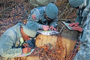 Natural terrain is used by soldiers from 266th Financial Management Support Center to plot their points for the Best Warrior Competition March 1 on Rhine Ordinance Barracks. Soldiers have two hours to find four points.
