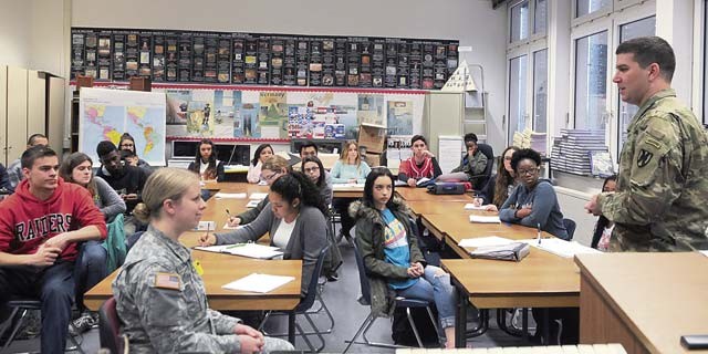 Capt. Jennifer Bromm, trial counsel, and Capt. Matt Montazzoli, administrative law attorney, both of the 21st Theater Sustainment Command, provide legal information to junior and senior students in Mark Fairchild’s Street Law class March 25 at Kaiserslautern High School on Vogelweh. These students are preparing for the upcoming mock trial to be held as part of the 21st TSC Law Day celebration on May 2. 