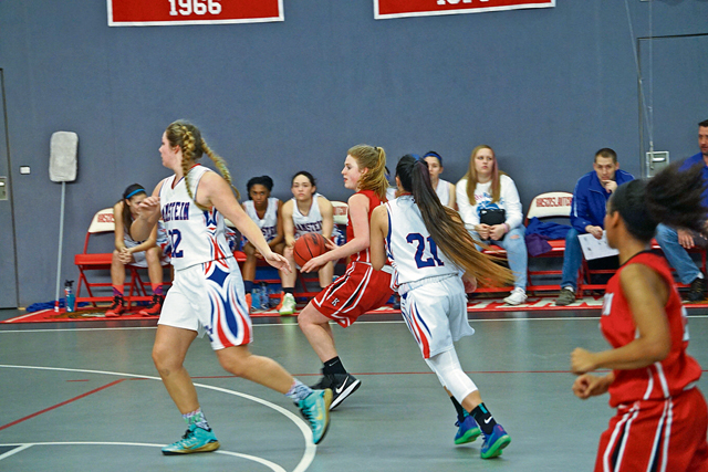 Photo by Saniyah Mack Althea Honan, 11th-grader at KHS, dribbles down the court during the DODDS-Europe girls basketball championships against RHS. 