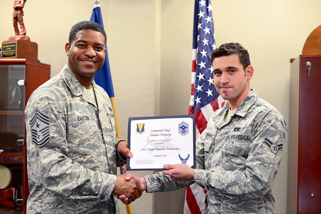 Airman First Class Nader Hussein-Fernandez, an aerospace ground equipment technician with the 86th Maintenance Squadron (right), receives a certificate of recognition from 86th Airlift Wing Command Chief Philip L. Easton, March 3 on Ramstein. Hussein-Fernandez was the first to participate in Easton’s shadow program at Ramstein, allowing him the opportunity to witness life as a wing command chief for a day.