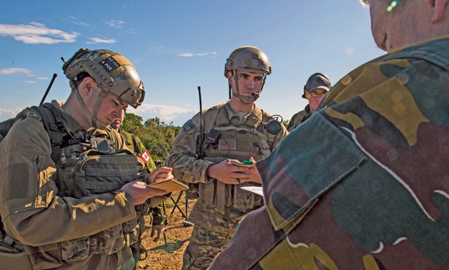 Tech. Sgt. Jeremy Rarang (left) and Senior Airman Gage Duvall (center), 2nd Air Support Operations Squadron joint terminal attack controllers, interact with Belgian JTACs during exercise Serpentex 16 March 7 in Corsica, France.