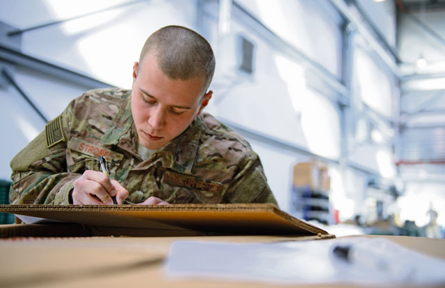 Senior Airman Zachary Strobel, 435th Contingency Response Squadron contingency aerospace maintenance journeyman, signs a receipt for equipment April 11 on Ramstein. Strobel is part of a deployment team from the 435th CRS going to stand up a base from a piece of flat land.