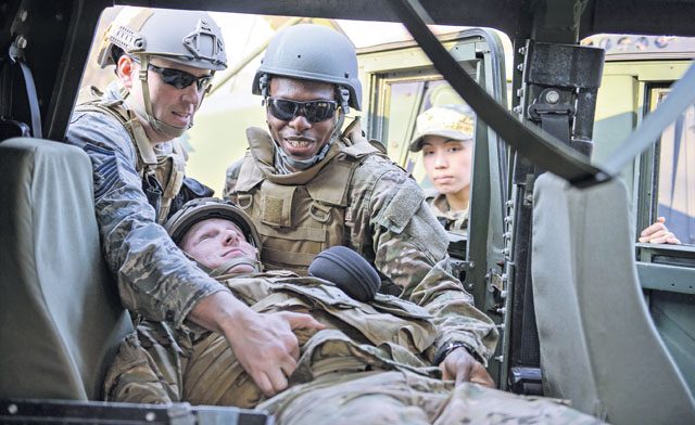 Airmen from the 435th Air Ground Operations Wing practice recovering an “injured” teammate April 11 on Ramstein. Instructors from the 435th Security Forces Squadron guided the Airmen in best practices to ensure the safety and security of the deploying Airmen.