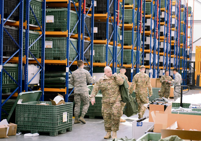 Airmen from the 435th Air Ground Operations Wing receive deployment gear in preparation for a deployment April 11 on Ramstein. The 435th AGOW is preparing to complete one of its primary missions of building air bases from the ground up.