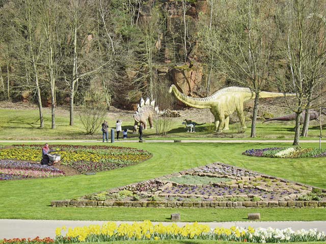 Families enjoy walking amongst the dinosaurs while gardeners take care of the spring flowers.