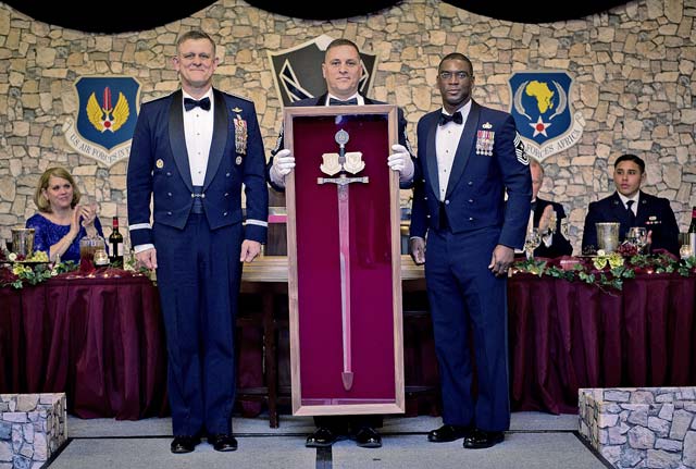 Photos by Tech. Sgt. Ryan CraneGen. Frank Gorenc, U.S. Air Forces in Europe and Air Forces Africa commander, is presented his personal sword by Command Chiefs Samuel Simmons (center) and James Davis (right) during an Order of the Sword ceremony April 7 on Ramstein. The Order of the Sword is a special program where noncommissioned officers of a command recognize individuals who have made significant contributions to the enlisted corps. Gorenc is the 20th USAFE-AFAFRICA commander to be awarded this honor.