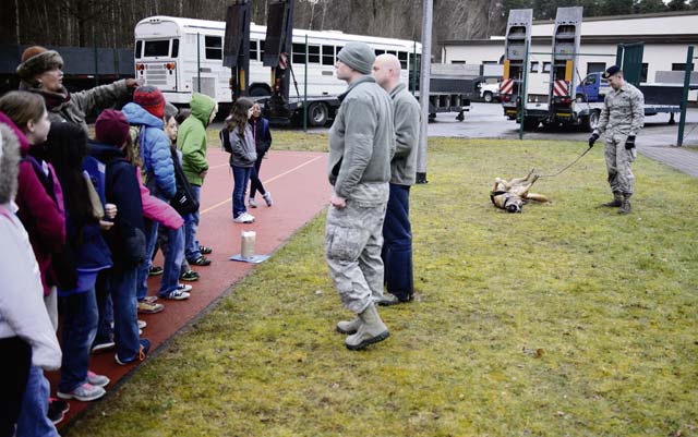Photo by Staff Sgt. Armando Schwier-MoralesAirmen from the 86th Security Forces showcase a Police K-9 to children April 1 at Ramstein Intermediate School. The children underwent a mock deployment to understand the process and events their parents may see during a deployment.