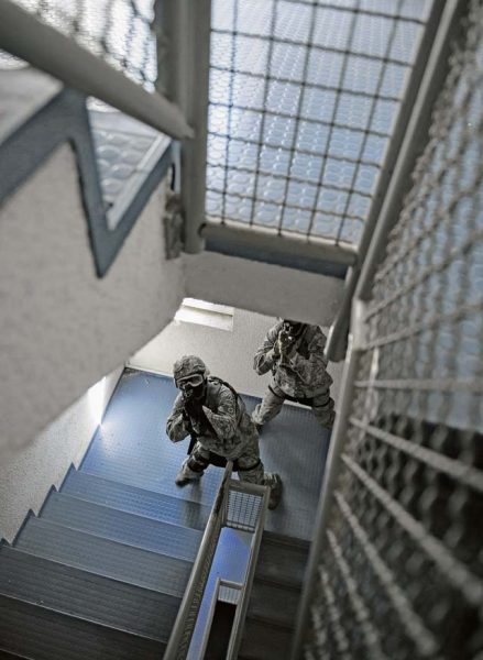 Photo by Senior Airman Damon Kasberg Staff Sgt. Steffan Roverud and Senior Airman Eric Beougher, 569th U.S. Forces Police Squadron patrolmen, clear a stairwell during an active-shooter training May 5 on Vogelweh. During the training, the Airmen were required to move through a building in a two-man team to locate the simulated active shooter.