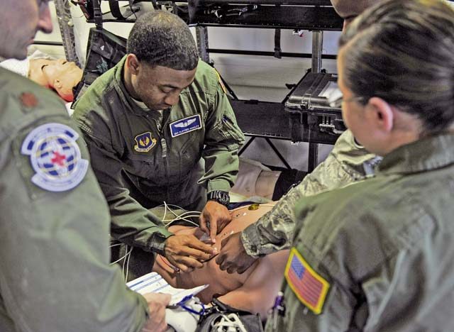 Senior Airman Clifford Hughley, 86th Aeromedical Evacuation Squadron technician (center), prepares a simulated patient for an electrocardiogram during an exercise May 12 on Ramstein. Nurses and technicians work a fast-paced job, but they were able to spend time out of the office during Nurses and Technicians Appreciation Week.