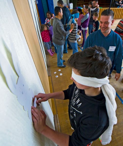 Marcee pins a tail on the rabbit during a community engagement event led by Airmen from Ramstein April 23 in Landstuhl. During the event, the Airmen and children spent time learning from each other through games and building friendships.