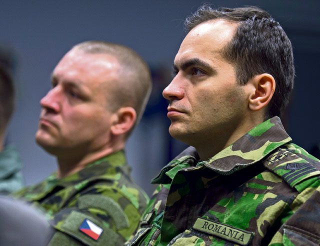 A Romanian air force service member listens to a guest speaker as the first Inter-European Air Forces Academy inaugural in-residence Squadron Officer School and NCO Academy class kicks off April 25 on Ramstein.