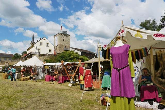 Vendors sell a variety of merchandise during a medieval market set up at the bottom of Wasserburg, a moated castle in Reipoltskirchen, Saturday and Sunday.