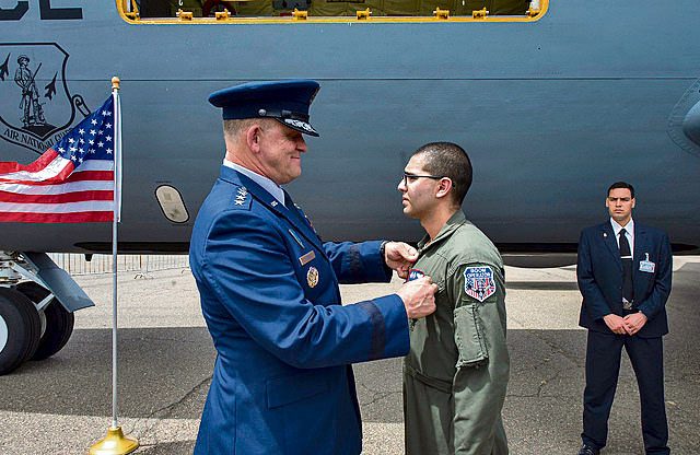 Gen. Frank Gorenc, U.S. Air Forces in Europe and Air Forces Africa commander, presents Airman 1st Class Eric Acevedo with his new rank during his promotion ceremony at the International Marrakech Air Show April 28 in Morocco. U.S. Air Force members attended the air show as a gesture of partnership with the host Moroccan nation and to promote regional security throughout the continent of Africa.