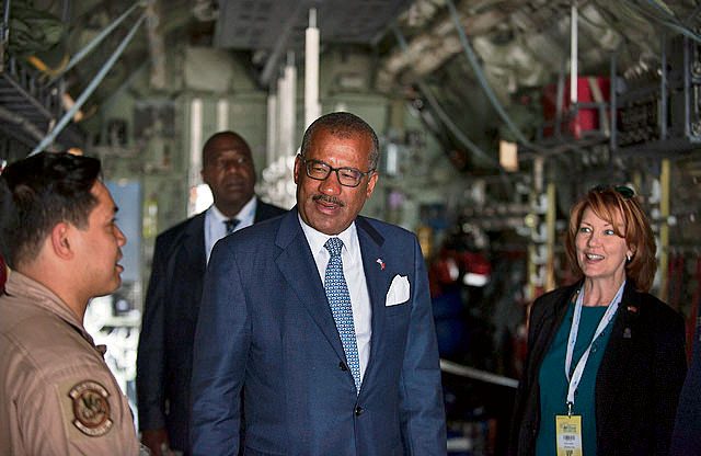 Dwight Bush, U.S. ambassador to Morocco (center), speaks with crew members of a C-130J Hercules from Ramstein during the International Marrakech Air Show April 28 in Morocco.