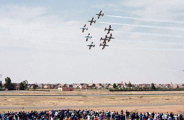 The audience looks to the sky as pilots with the Italian air force aeronautical team demonstrate their aircraft’s in-flight capabilities during the International Marrakech Air Show April 30 in Morocco.