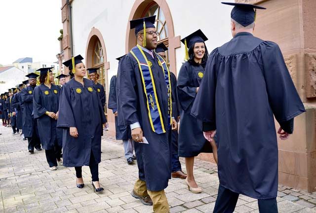 The University of Maryland University College Europe class of 2016 joyfully marches into the event hall to receive well-deserved degrees April 30 at the Gartenschau in Kaiserslautern. 