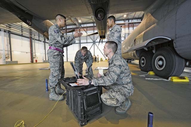 Tech. Sgt. Roscoe Tamondong, 86th Maintenance Group NCO in-charge instructor element (left), gives Airmen in the crew chief training course guidance on performing tire pressure checks on a C-130J Super Hercules May 17 on Ramstein. Tamondong is one of four training instructors assigned to the 86th MXG.