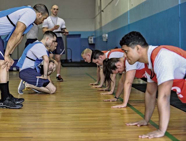 Senior Airman Peter Sulli, 86th Security Forces Squadron patrolman and physical training leader, times Airmen during the pushup portion of a fitness assessment April 12 on Ramstein. The fitness assessment cell trains roughly 100 PTLs and 20 unit fitness program managers each month.