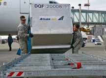 Senior Airman Cornel Griffen and Airman 1st Class Paul Boughner, 721st Aerial Port Squadron passenger service agents, load cargo containers onto a platform Jan. 27 on Ramstein. These platforms are used to quickly transport cargo around the flightline.