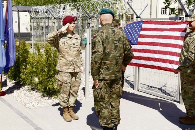 Courtesy photo U.S. Army Capt. Briana Bailey salutes Polish army Col. Artur Bogowicz, NATO Force Integration Unit Poland commander, after he promoted her outside of the NATO Force Integration Unit headquarters building May 6 in Bydgoszcz, Poland. NATO established six NFIUs following the 2014 Wales Summit, a meeting of the NATO heads of state. Each of these NFIUs has about 40 personnel, including a major and lieutenant from the 16th Sustainment Brigade, 21st Theater Sustainment Command.