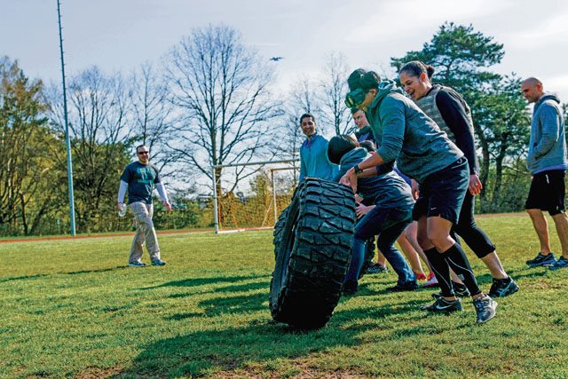 A team of Soldiers flip a tire during the Courage, Leadership, Education, Advocate and Respect course April 29 on Vogelweh.