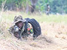 A Cameroonian armed forces soldier wearing an American flag patch works alongside U.S. Army Soldiers to secure a checkpoint during a simulated tactical movement at this year’s Central Accord exercise June 21 in Libreville, Gabon.