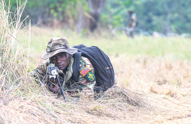 A Cameroonian armed forces soldier wearing an American flag patch works alongside U.S. Army Soldiers to secure a checkpoint during a simulated tactical movement at this year’s Central Accord exercise June 21 in Libreville, Gabon.
