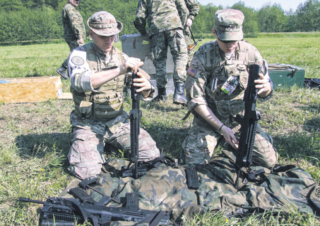 Senior Airman Tormod Lillekroken, 2nd Air Support Operations Squadron joint terminal attack controller, and a U.S. Army Soldier reassemble a weapon during the Croatian Best Soldier competition May 12 in Grubisno Polje, Croatia.