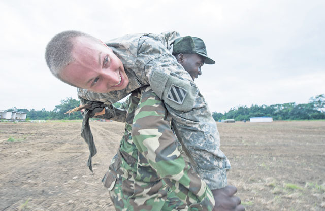 A Gabonese armed forces soldier carries Spc. Ridgely, an infantryman with the 3rd Battalion, 7th Infantry Regiment, 2nd Brigade Combat Team, 3rd Infantry Division, during a tactical combat casualty care course at this year’s Central Accord exercise June 17 in Libreville, Gabon.