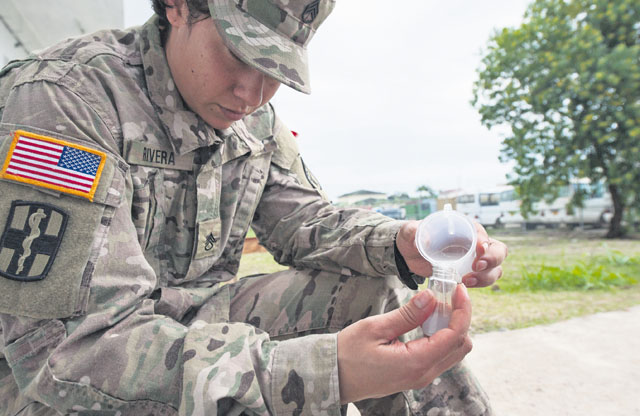 Staff Sgt. Christina Rivera, Landstuhl Regional Medical Center healthcare specialist, tests the chlorine balance of the hand-washing station used by U.S. military members and their partners during this year’s Central Accord exercise June 18 in Libreville, Gabon. 