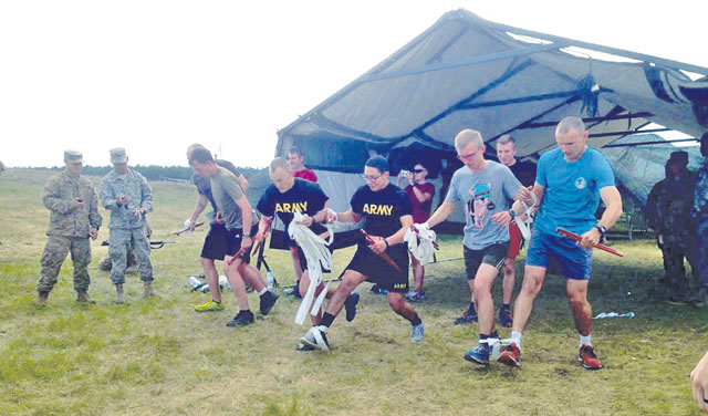 Photo by Capt. Richard SkinnerSoldiers from 421st Medical Battalion (Multifunctional); Polish 1st Army Field Hospital, 10th Military Hospital; and the U.K.’s 16th Medical Regiment team up for the three-legged relay race during the “Torun Games” June 8 in Torun, Poland. 