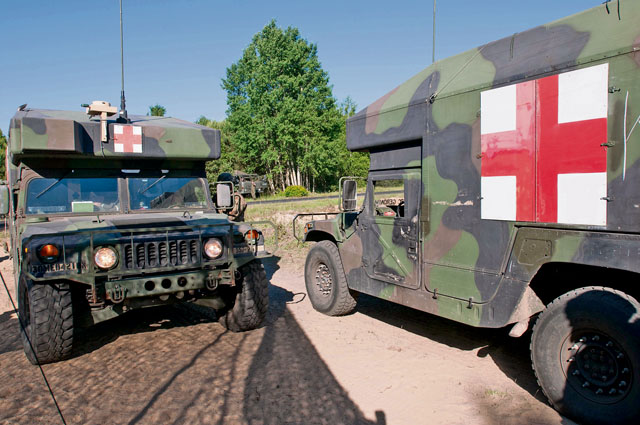 Photo by Capt. Jeku ArceGround ambulances from the 557th Medical Company finish unloading injured paratroopers next to the drop zone during Swift Response 16 on June 7 in Poland.