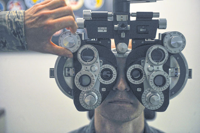 A patient looks through a phoropter during an optometry exam June 23 on Ramstein. The 86th Aerospace Medicine Squadron optometry clinic supports roughly 54,000 Americans, making it the largest American population outside of the continental U.S. 