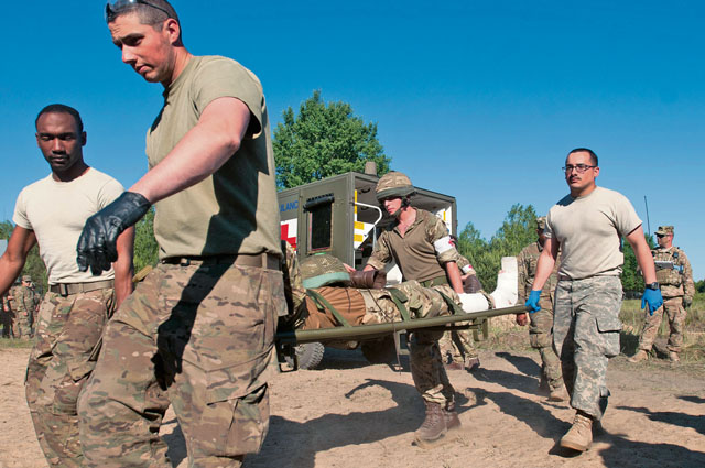 Photo by Capt. Jeku ArceMedics from the 557th Medical Company and U.K.’s 16th Medical Regiment carry an injured paratrooper from a Polish military ambulance to the medical facilities next to the drop zone during Swift Response 16 June 7 in Poland.