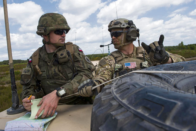 Tech. Sgt. Cody Quinn, 15th Air Space Operations Squadron training NCO in charge, helps a Polish joint terminal attack controller as they coordinate a training event during exercise Anakonda 2016 June 10 in Poland. Anakonda 2016 is a multinational exercise that seeks to train, exercise and integrate Polish national command force structures into an environment involving other countries. This exercise further supports assurance and deterrence measures by demonstrating allied defense capabilities.