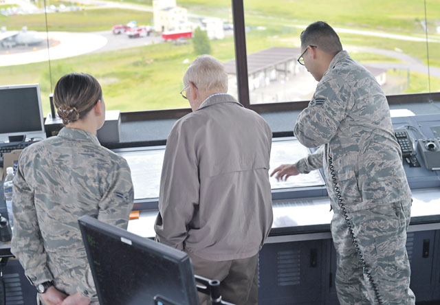 Retired Chief Master Sgt. Kenneth Andrews meets with several Ramstein Airmen during a visit to the air traffic control tower May 24 on Ramstein. Andrews had the opportunity to speak to the controllers on duty that day and share with them his background as a 30-year retired traffic controller. Andrews entered the Air Force in 1947 and retired in 1977 after having served in several combat roles during his military career.